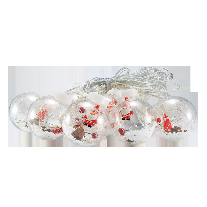 Lichtervorhang mit Weihnachtskugeln und Weihnachtsfiguren