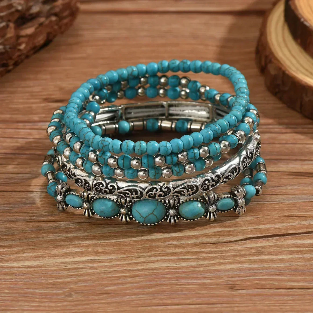 Set aus 5 Armbändern mit türkisfarbenen Perlen und silberfarbenen Details.